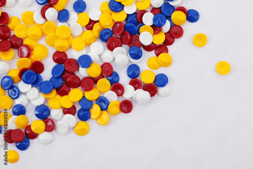 colorful industrial plastic pellets on white background