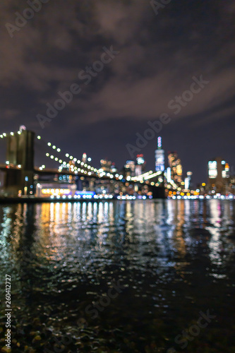 Blurred view of Financial District at night from East River