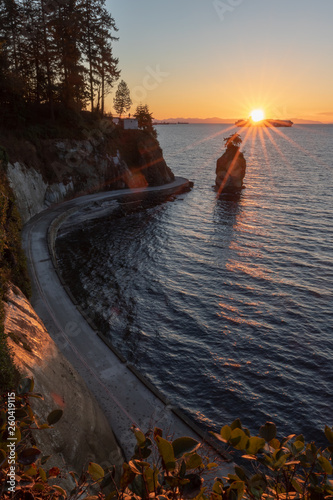 Sunset through the leaves looking at Siwash Rock in Vancouver Canada photo