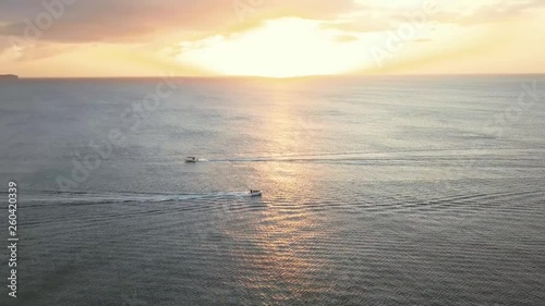 two boats with sunset
