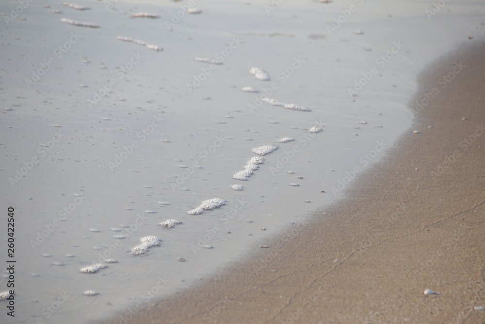 Bubble Foam of Sea Wave on the sand Beach Bubble Foam of Sea Wave on the sand Beach