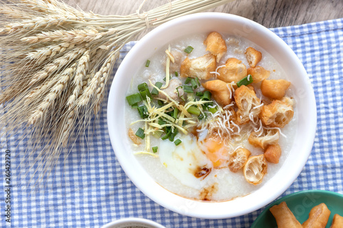 Breakfase meal. Congee or Rice porridge minced pork, boiled egg with soy milk and Chinese deep fried double dough stick photo