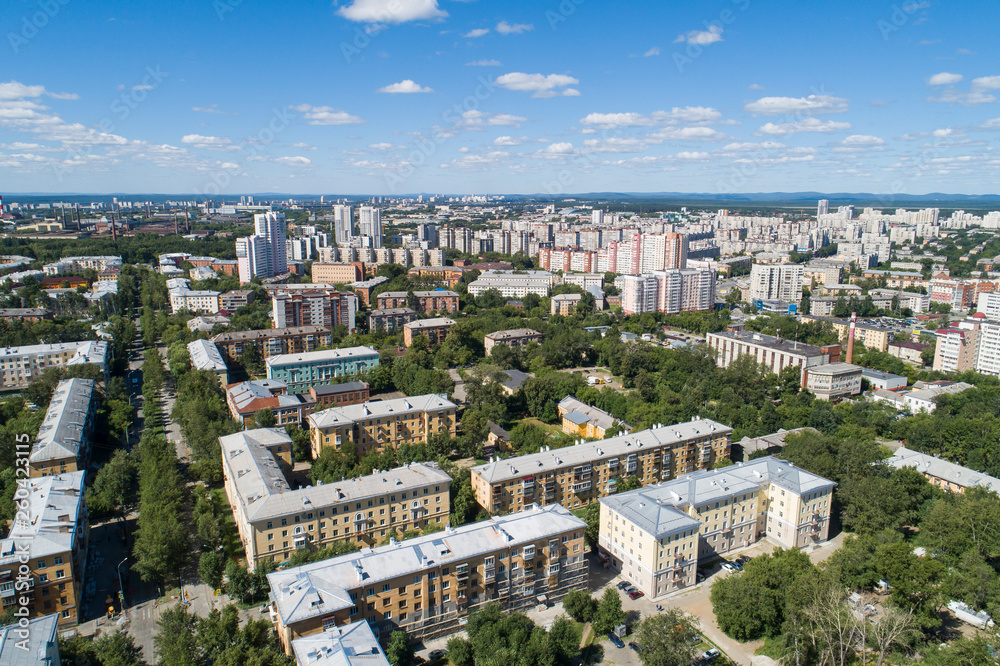 Top down aerial drone image of a Ekaterinburg city in the midst of summer, backyard turf grass and trees lush green.