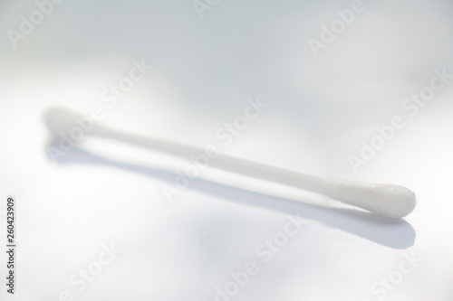 One white plastic cotton buds on white table texture background  Close up   Macro shot  Selective focus  Light   shadow  About Cleaning Body  Healthcare concept