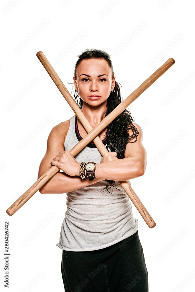 Athletic strong woman training with two wooden exercise sticks Athletic strong woman training with two wooden exercise sticks