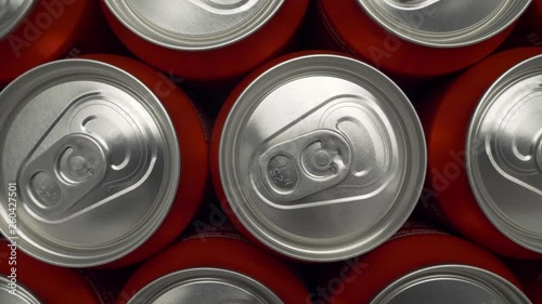 refrigerator clogged with cans of soda. aluminum cans of beverage lie in an filled fridge. Cans with beer on a shelf in the refrigerator. dolly slow motion shot close up medium