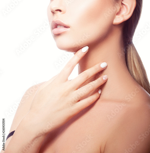Partial beauty portrait of young model girl  clean skin  natural make-up  hand near neck