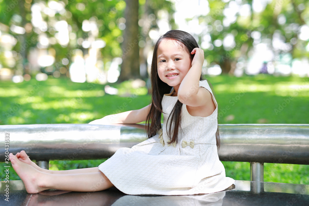 Portrait of smiling little Asian child girl in sunny green park. Portrait of smiling little Asian child girl in sunny green park.