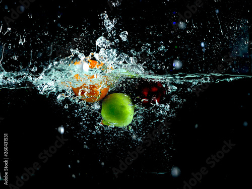 Splashing fruit into water.