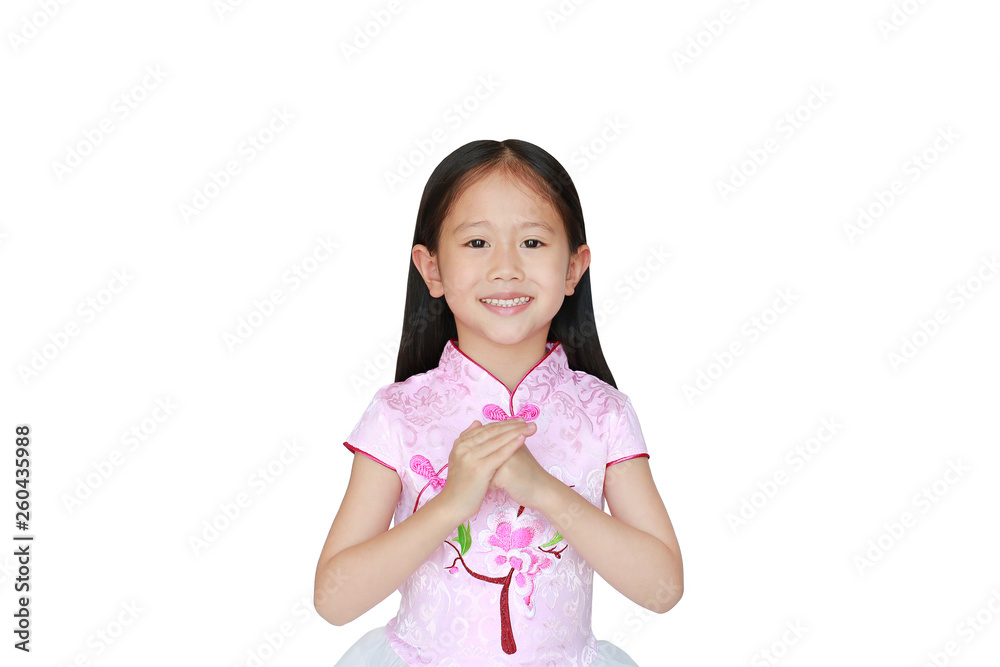 Smiling little Asian child girl wearing pink traditional chinese dress with greeting gesture celebration for Chinese New Year isolated on white background. Smiling little Asian child girl wearing pink traditional chinese dress with greeting gesture celebration for Chinese New Year isolated on white background.