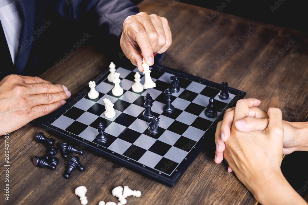 hand of businessman moving chess figure in competition board game for development analysis, strategy idea management or leadership concept. hand of businessman moving chess figure in competition board game for development analysis, strategy idea management or leadership concept.