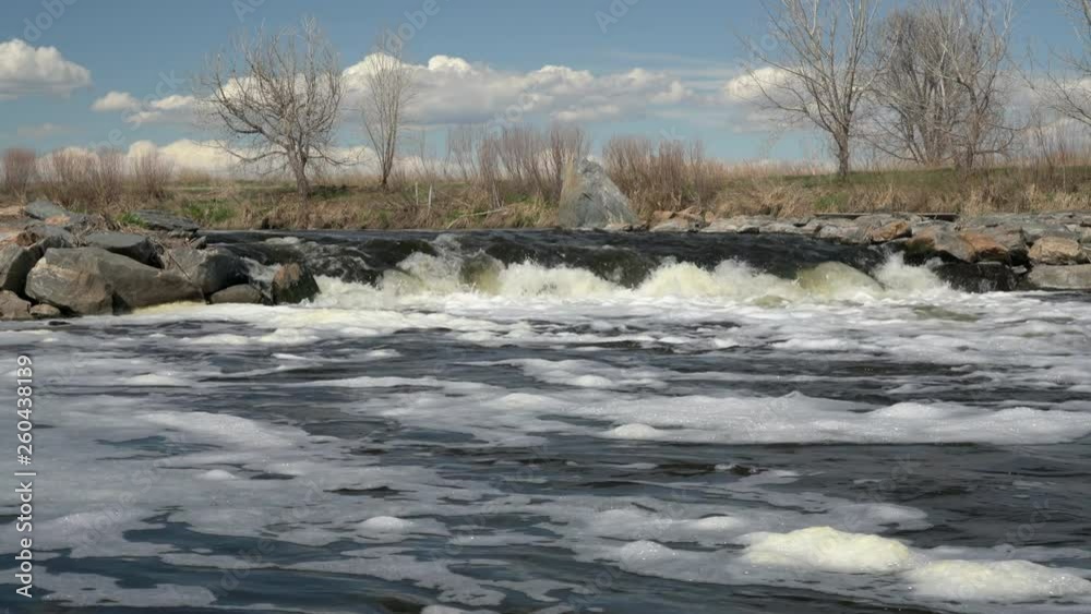 South Platte River at Brighton, Colorado - one of numerous grade control drop structures with a boat chute, early spring scenery with a low flow South Platte River at Brighton, Colorado - one of numerous grade control drop structures with a boat chute, early spring scenery with a low flow