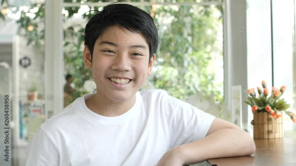 Close up portrait of asian attractive boy smiling confident pretty Close up portrait of asian attractive boy smiling confident pretty