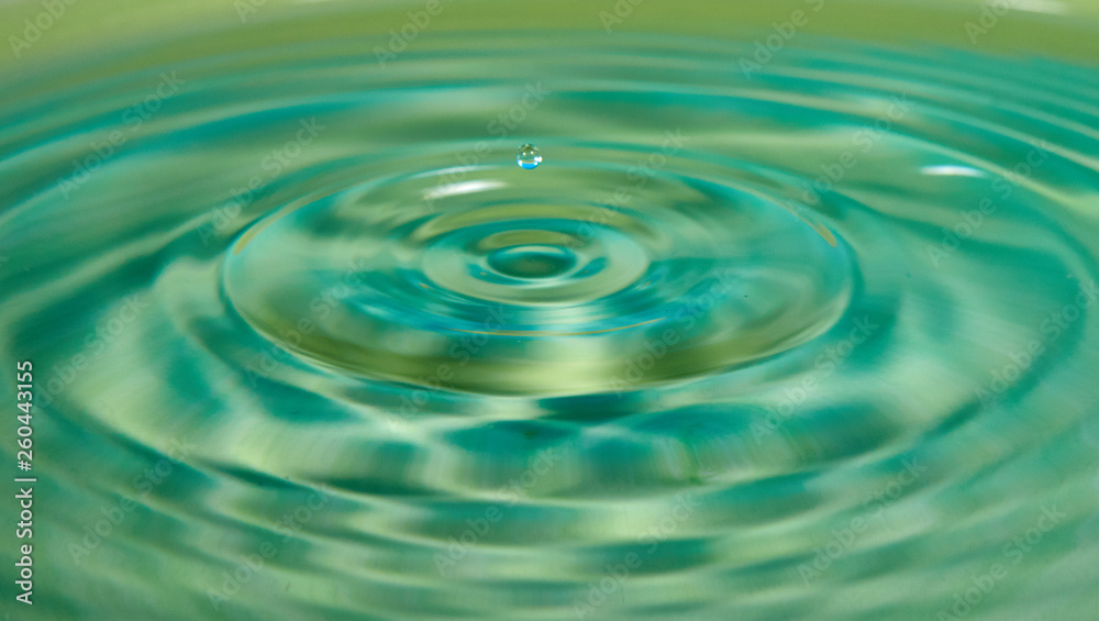Drop of water or fluid created a ripple wave Drop of water or fluid created a ripple wave