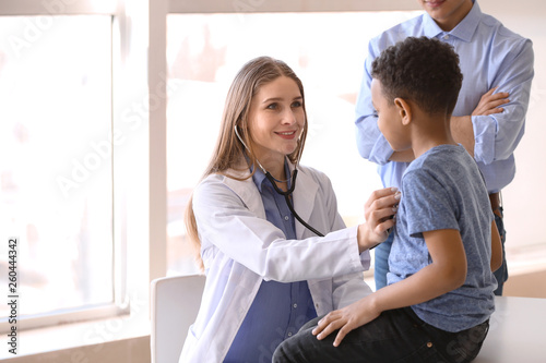 Pediatrician examining Afri...