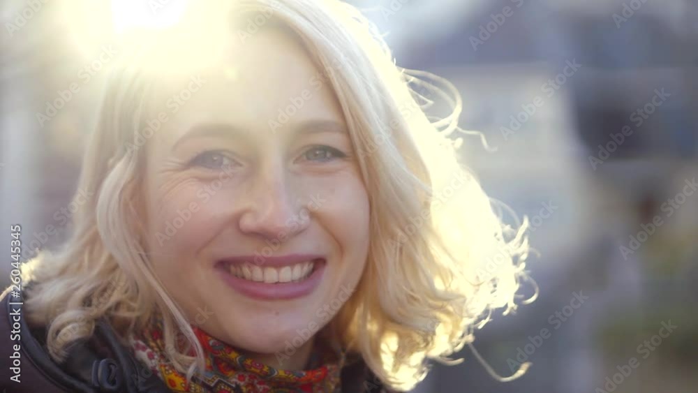 Amazing outdoor portrait of a blonde woman being happy and smiling. Amazing outdoor portrait of a blonde woman being happy and smiling.