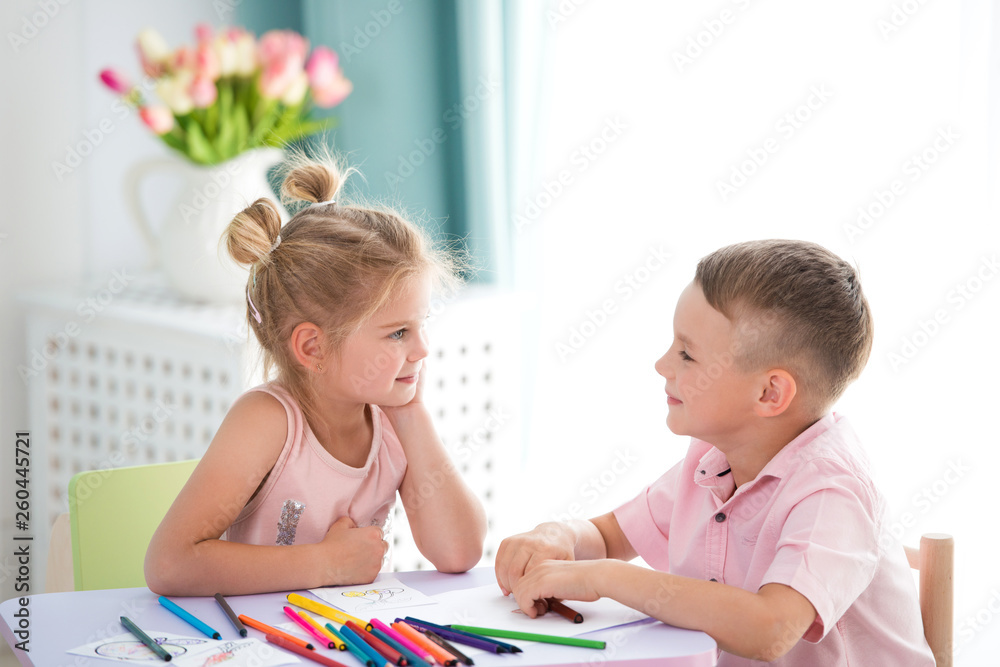 Little children play and draw with colorful pencils Little children play and draw with colorful pencils