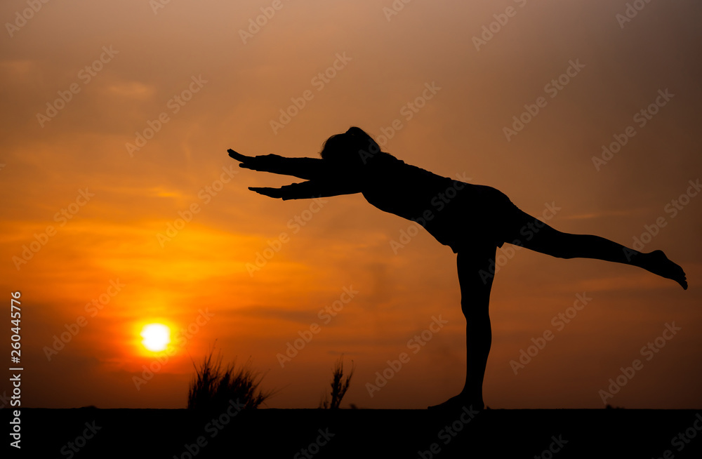 Silhouette Asia woman yoga on sunset. - Image