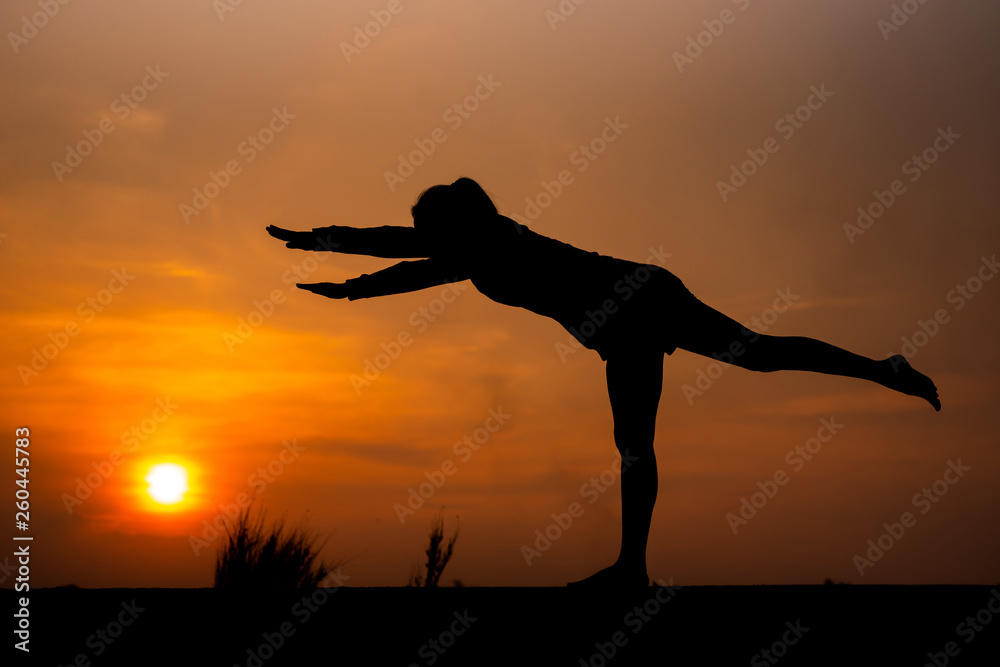 Silhouette Asia woman yoga on sunset. - Image