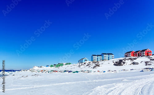 Colorful Inuit houses of Nuuk city with mountains in the background, Greenland