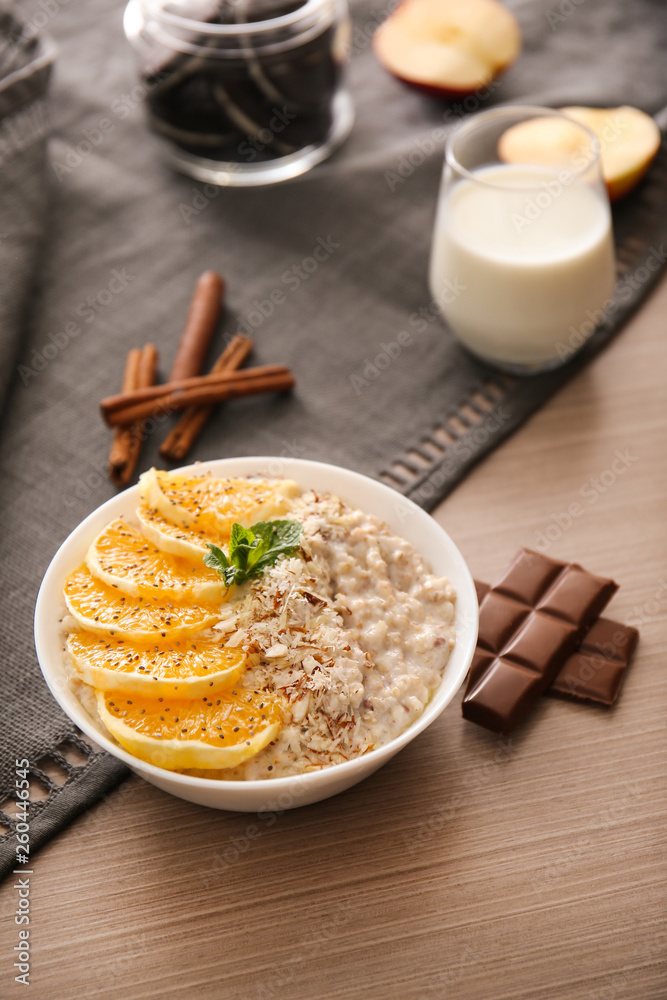 Bowl with tasty sweet oatmeal on wooden table Bowl with tasty sweet oatmeal on wooden table