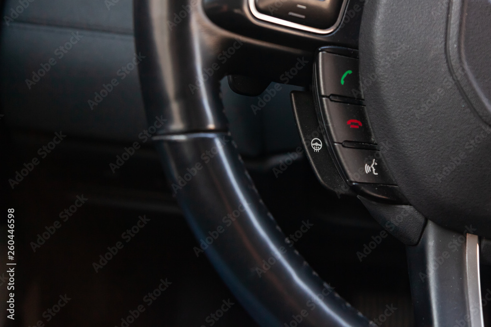 View to the interior of car with dashboard, steering wheel with heat and bluetooth buttons after cleaning before sale on parking