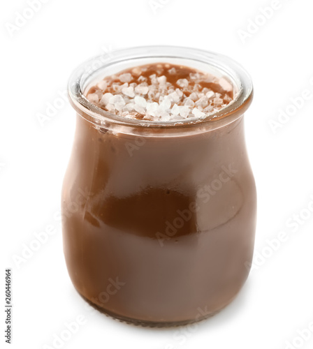 Jar of tasty salted caramel on white background