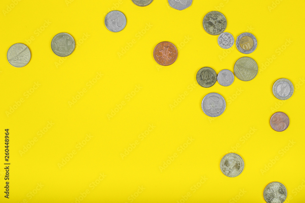 Coins on yellow background. Top view. Flat lay. Coins on yellow background. Top view. Flat lay.