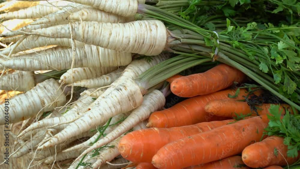 Close-up of healthy, organic vegetables at a market stall. On the shot you can see the carrot, parsley and green parts of the plants. A sunny morning. Close-up of healthy, organic vegetables at a market stall. On the shot you can see the carrot, parsley and green parts of the plants. A sunny morning.