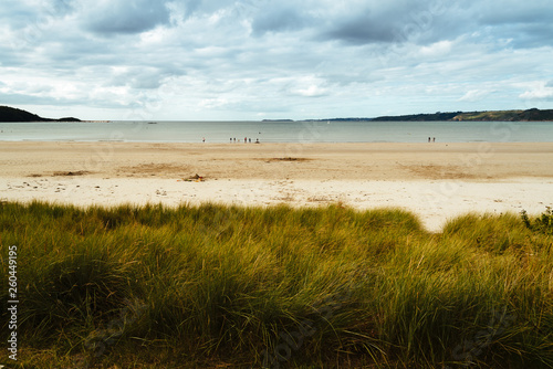 Tranquil beach against cloudy sky in Brittany