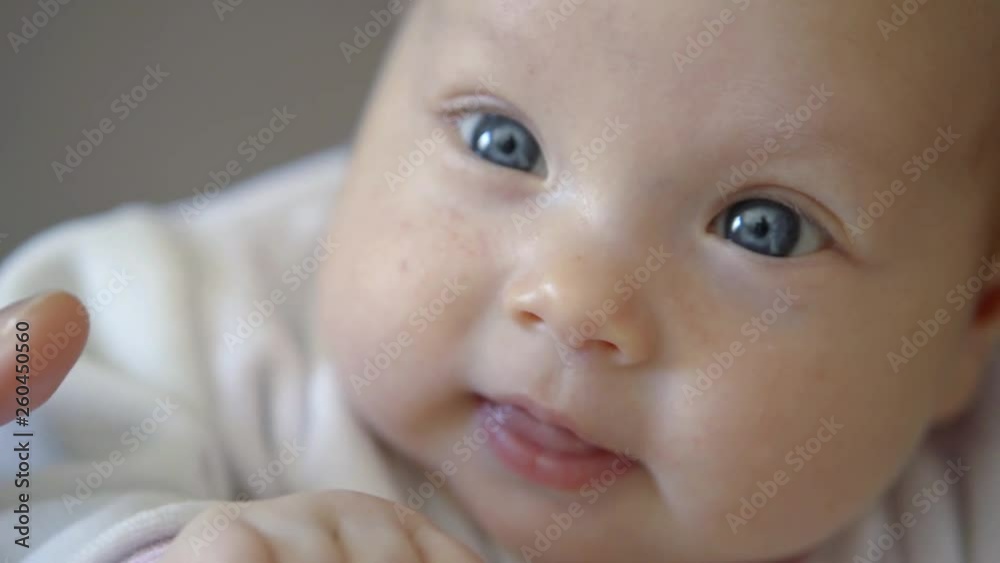 Close-up portrait of a adorable chubby baby with blue eyes looking at camera smiling. Close-up portrait of a adorable chubby baby with blue eyes looking at camera smiling.