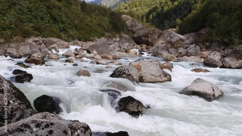 River with strong current and rocks in South of Chile photo