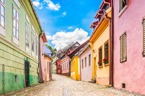 Old medieval cobblestone stree with colorful houses in Sighisoara, Transylvania, Romania