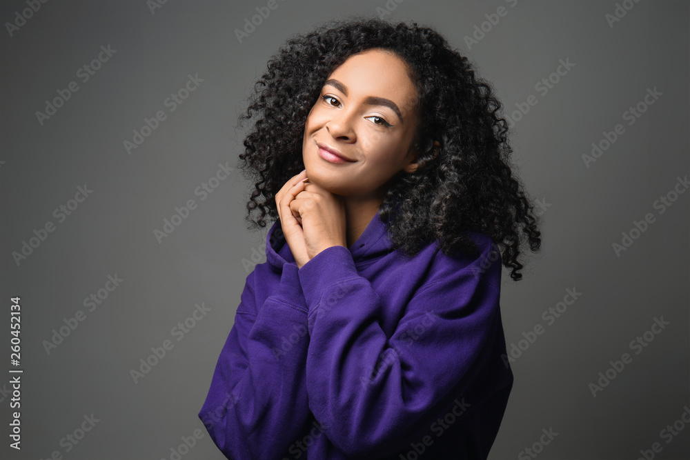 Beautiful African-American woman on grey background Beautiful African-American woman on grey background
