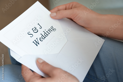 Woman holding envelope with...