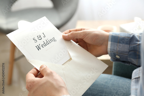 Man holding envelope with w...