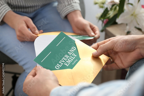 Couple with wedding invitat...