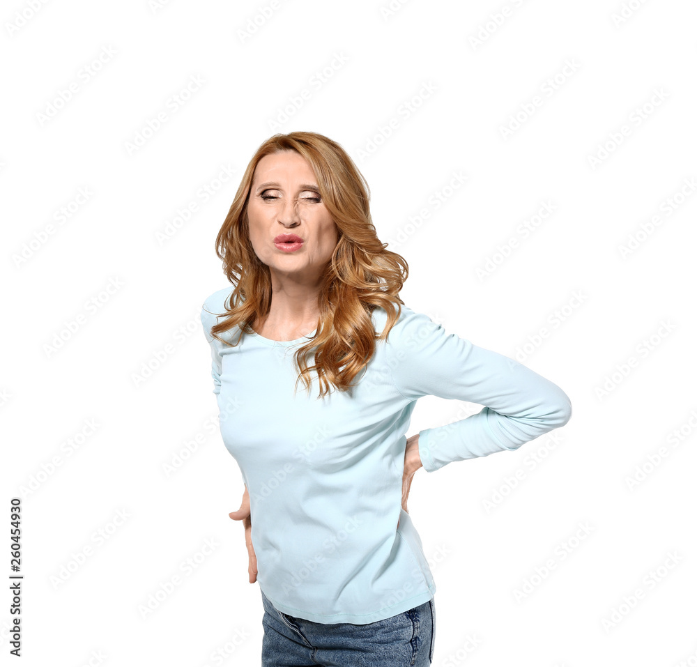 Mature woman suffering from back pain on white background