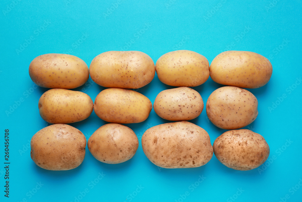 Raw potato on color background