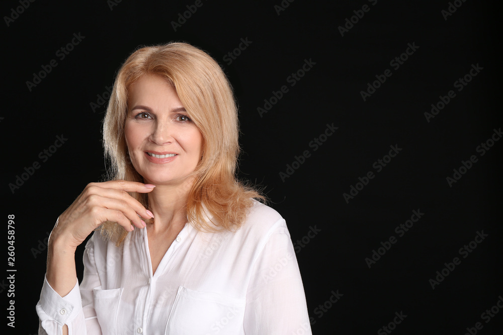 Stylish mature woman on dark background Stylish mature woman on dark background