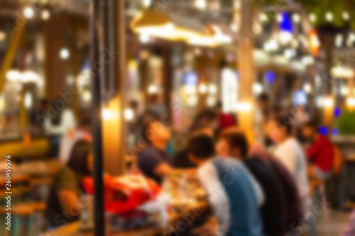 abstract blur image Lots of people enjoy the fun of night festival in a restaurant and The atmosphere is happy and relaxing. © piyaphunjun