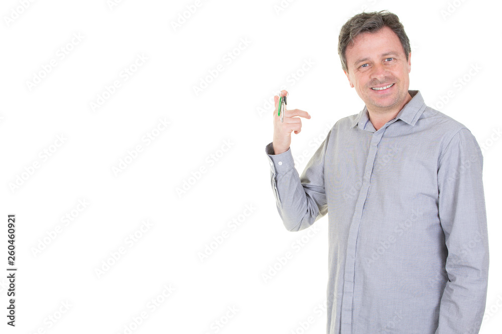 happy man in blue grey shirt holding keys with blank copy space happy man in blue grey shirt holding keys with blank copy space