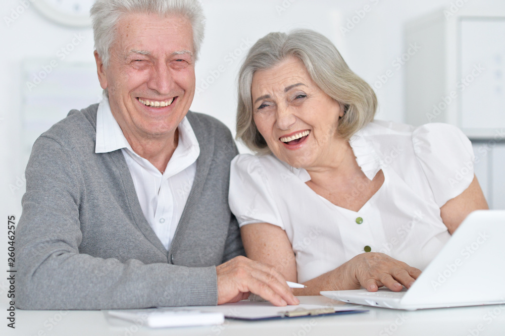 Close up portrait of smiling senior people working with computer at home Close up portrait of smiling senior people working with computer at home