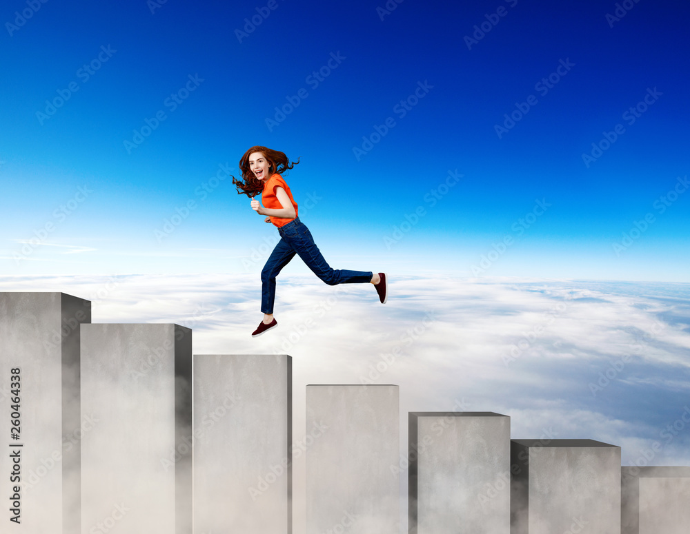 Young woman running up on the stairs blocks.