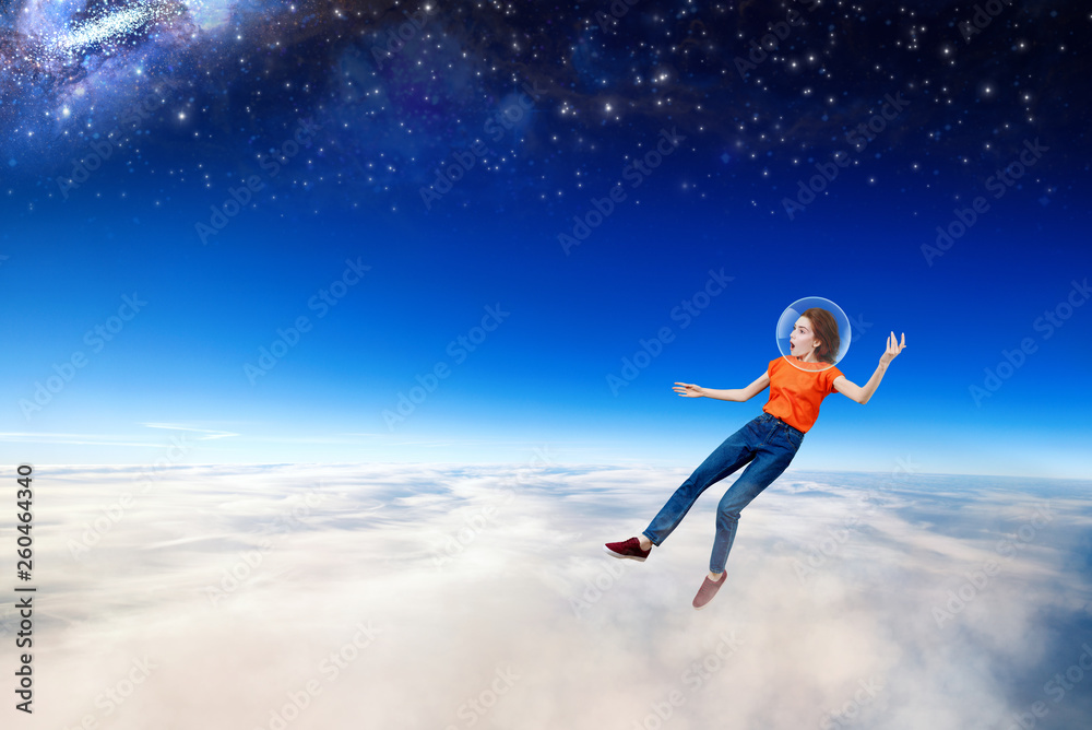 Young woman falling down from space in clouds sea.
