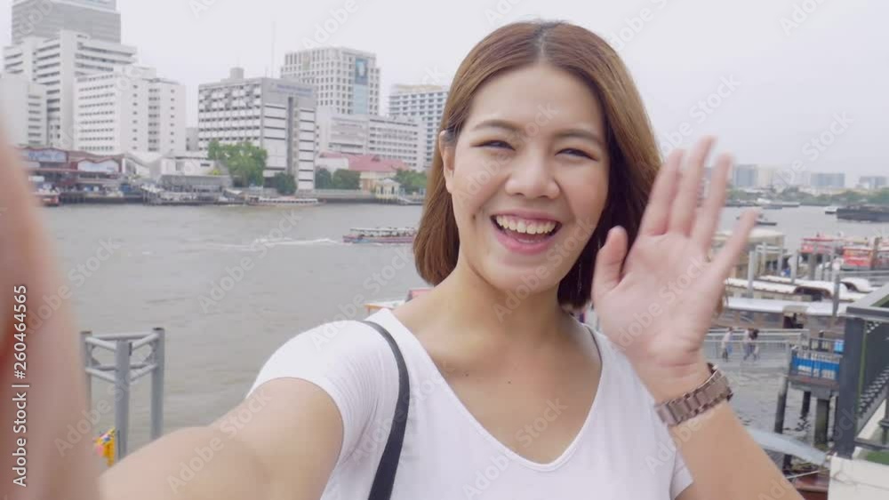 Smile beautiful asian woman taking selfies on a smartphone. Young asian girl tourist travel to thailand. Smile beautiful asian woman taking selfies on a smartphone. Young asian girl tourist travel to thailand.