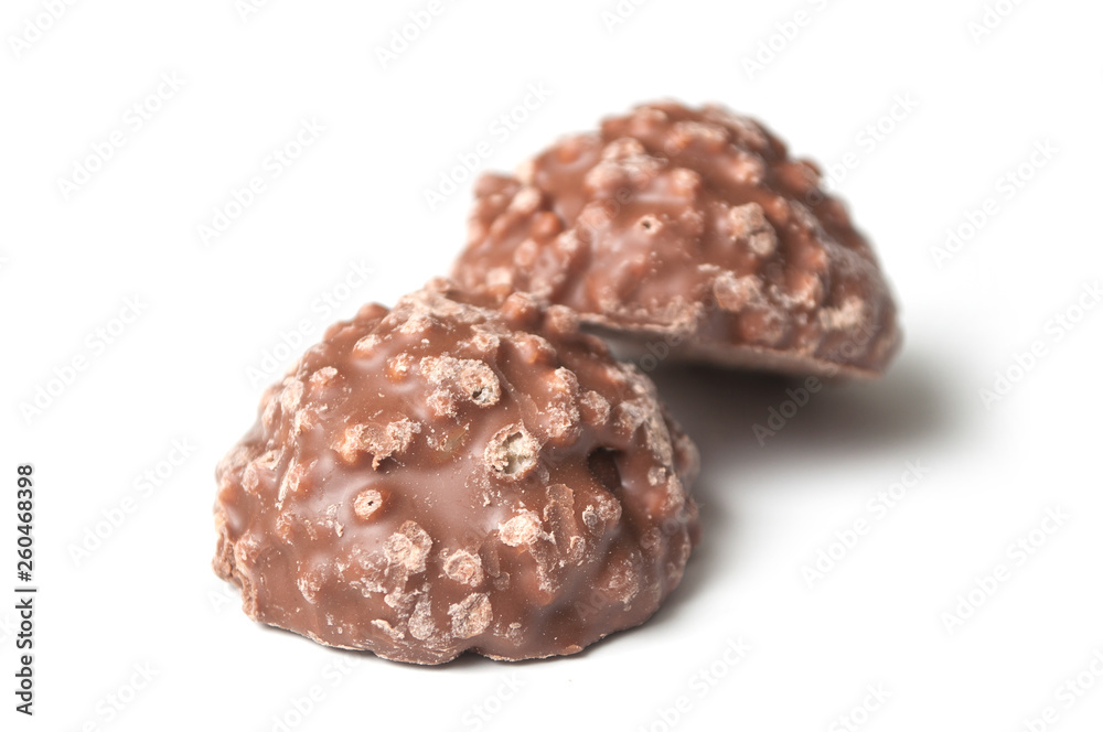closeup of milk chocolate in shaped rock on white background closeup of milk chocolate in shaped rock on white background