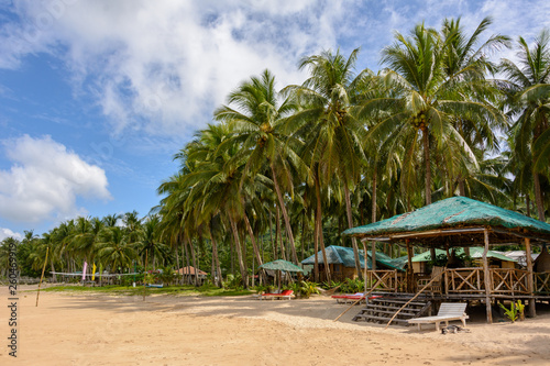Sandy beach with palm trees in El Nido, Palawan, Philippines. Tropical beach on an island in Asia.  © Maks_Ershov