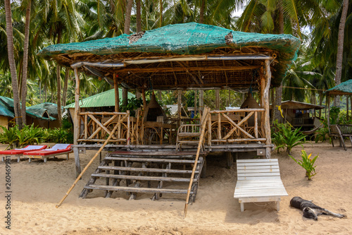 El Nido Beach, Philippines - wooden lounge area on a sandy beach © Maks_Ershov