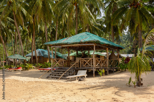 El Nido Beach  Philippines - wooden lounge area on a sandy beach